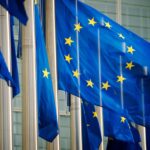 EU flags fly in a row in front of the European Commission building in Brussels, Belgium
