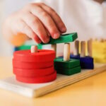 Kid playing with wood toys