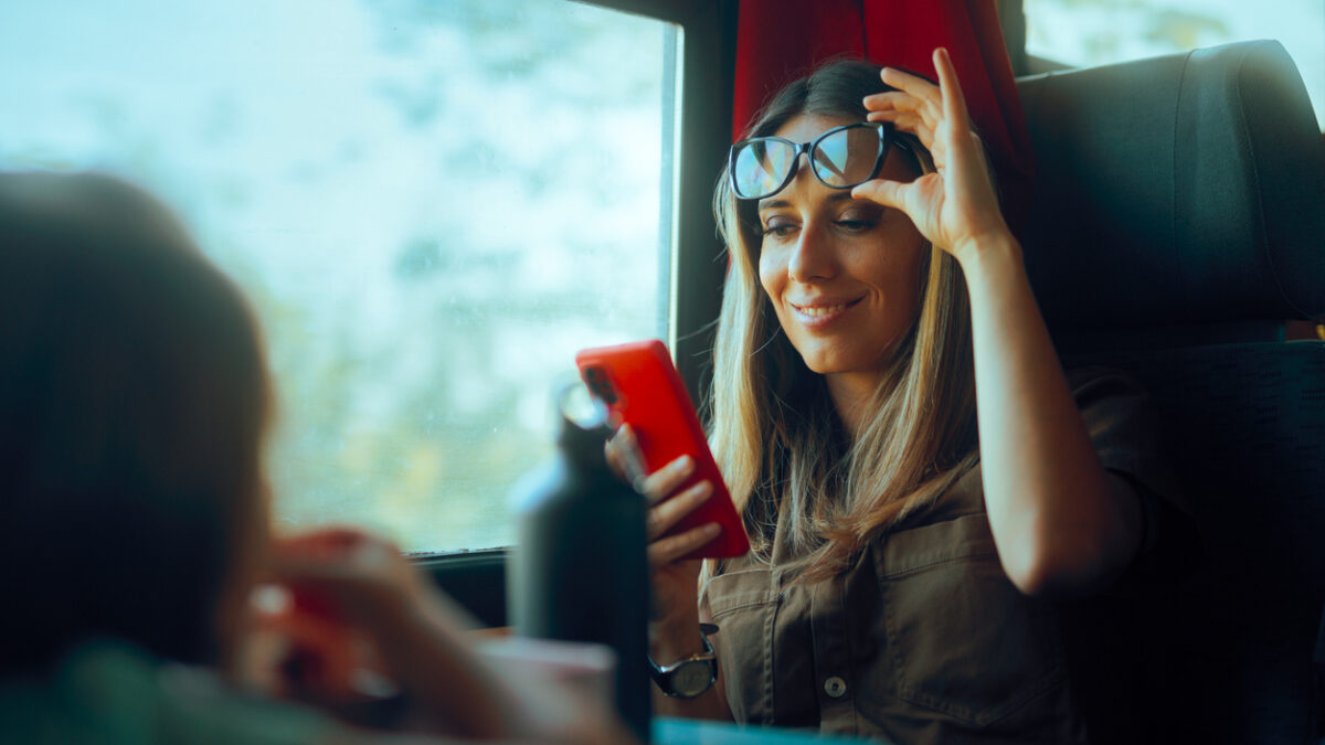 Happy woman checking her phone without glasses