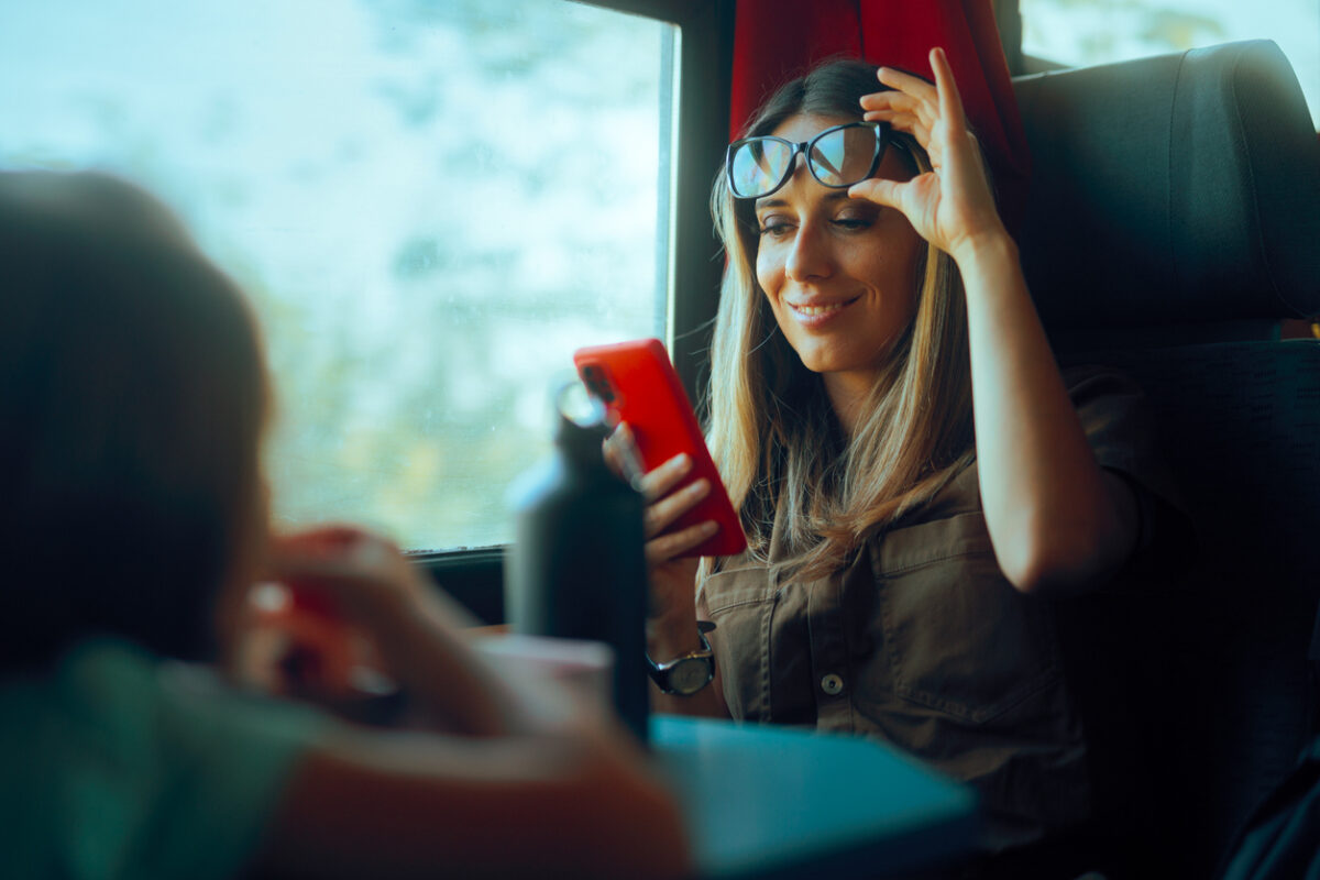 Happy woman checking her phone without glasses
