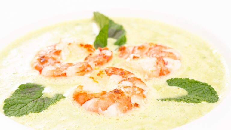 Close up of shrimps with green soup of mint