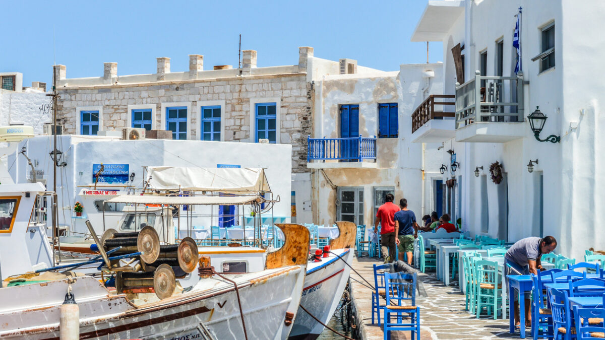Paros, Greece - June 17, 2016: Beautiful harbor of Naoussa on Paros Island. Picture was taken in the harbor where there is always activity from the may fishing boats and visitors that come to enjoy the scenary and get a bit to eat. At night the harbor is a thriving nightlife district.