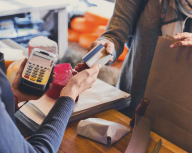 Retail, credit card payment service. Customer paying for order of cheese in grocery shop.