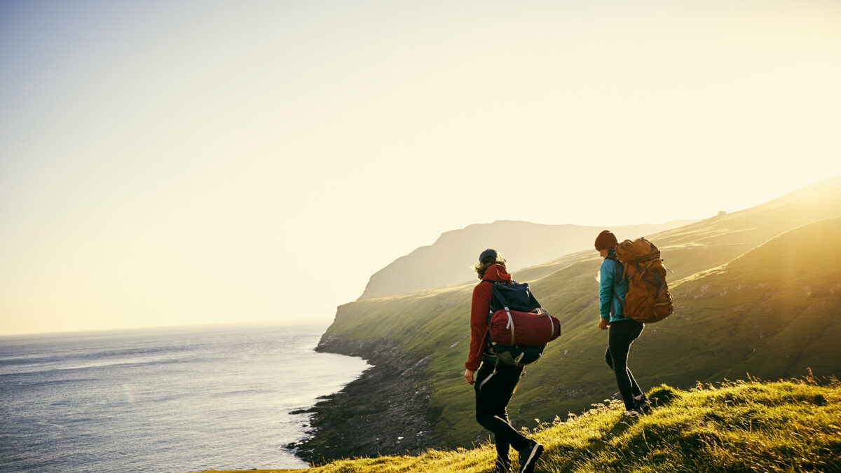 Shot of a young couple hiking through the mountains
