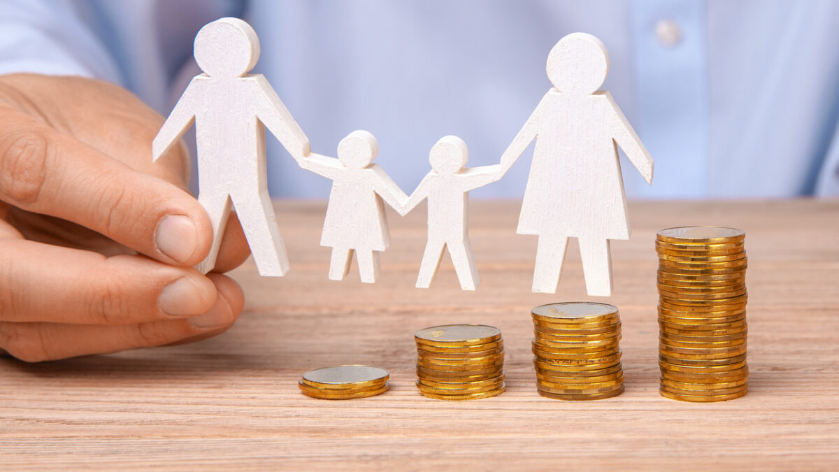 Budget of the family. Coins pile and the symbol of the family with the pope, mother, daughter and son