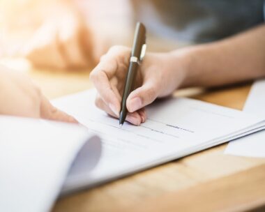 success business contract deasl with sale represent and clients meeting with paper document contract and pen close up on wooden table and background