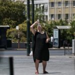 Γυναίκα προσπαθεί να δροσιστεί εξαιτίας του καύσωνα στην Αθήνα
