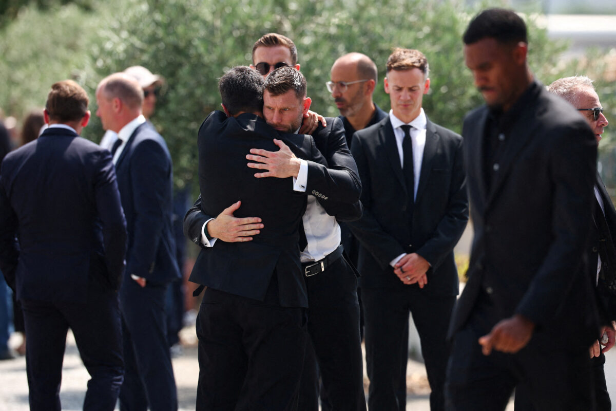 Former Liverpool player James Milner hugs a mourner, at the funeral ceremony of Liverpool's Portuguese soccer player Diogo Jota and his brother Andre Silva, who died in a car crash near Zamora, Spain, at the Chapel of the Resurrection, in Gondomar, Portugal, July 5, 2025. REUTERS