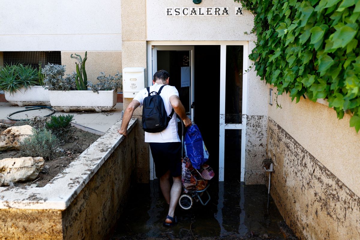 Resident of the village of Cubelles, in the province of Barcelona, is trying to get into a building after the Foix River overflows due to heavy rainfalls across the area
