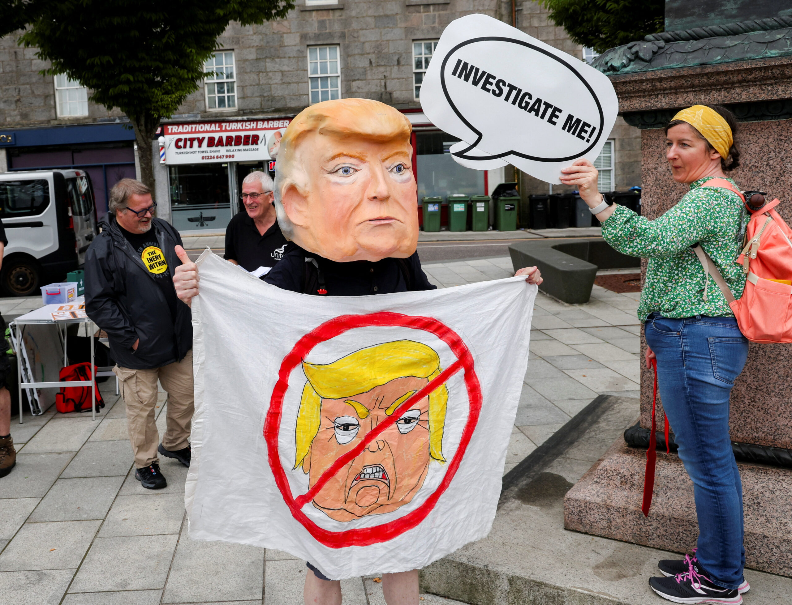 A demonstrator against Trump wears a cardboard in the form of US President Donald Trump in Aberdeen, Scotland / Reuters / Russell Cheyne