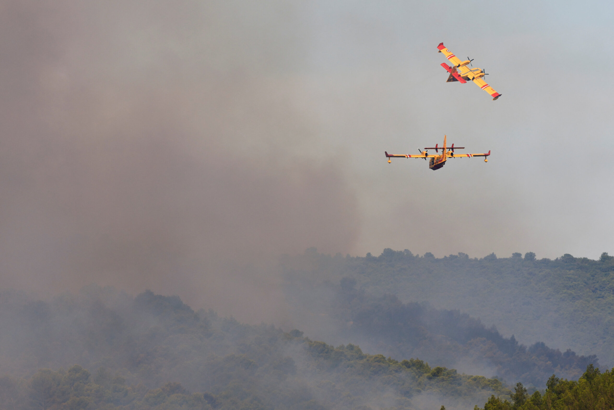 Canadair firefighters fly near the fire in southern France