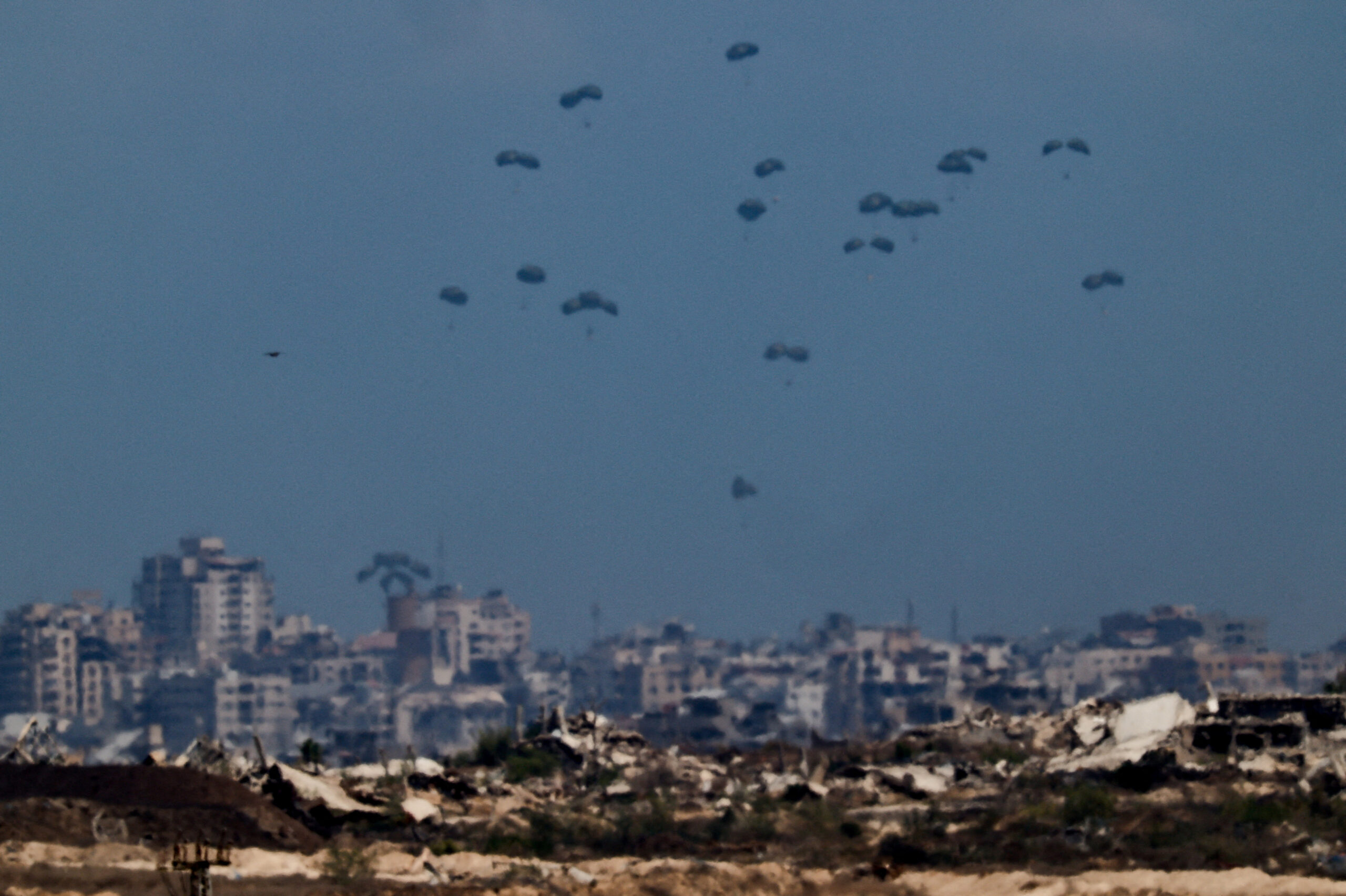 Humanitarian aid packages are thrown by air over the gauze