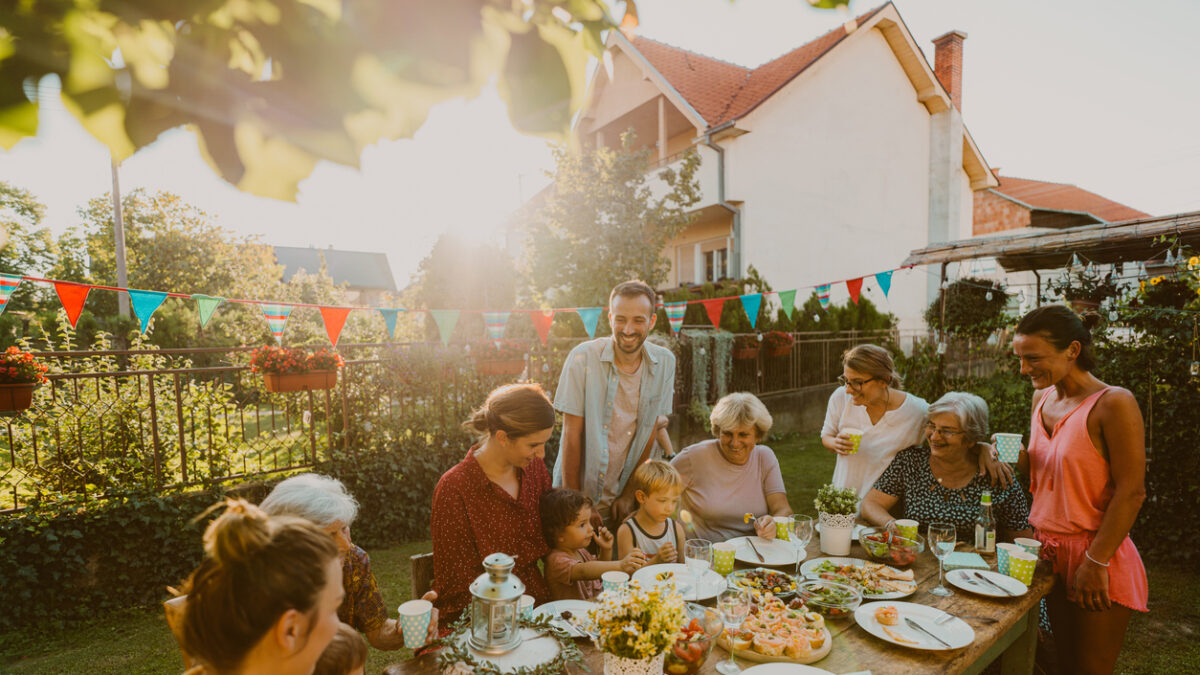Photo of multi generation family, having summer party in the backyard