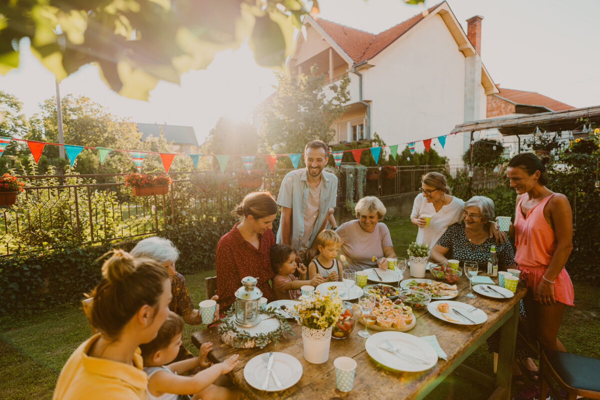Photo of multi generation family, having summer party in the backyard