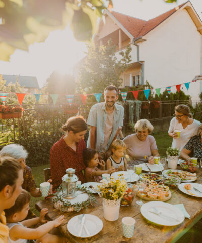 Photo of multi generation family, having summer party in the backyard