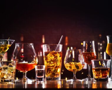 Assortment of hard strong alcoholic drinks and spirits in glasses on bar counter