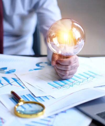 Businessman holding a big light bulb