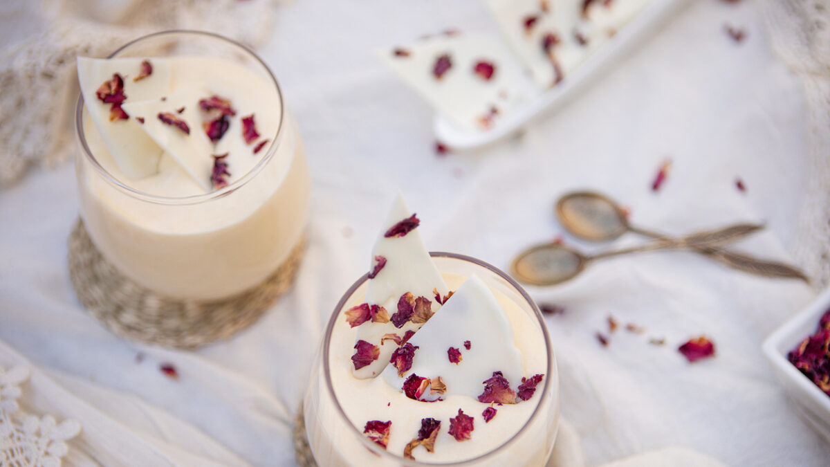 Delicious white chocolate mousse dessert with rose petals served in a glass cup - Argentine culture - Buenos Aires - Argentina