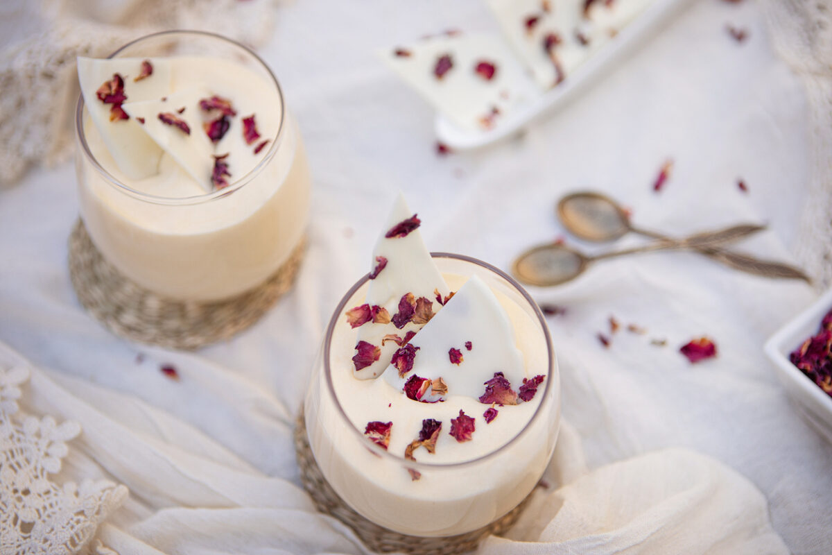 Delicious white chocolate mousse dessert with rose petals served in a glass cup - Argentine culture - Buenos Aires - Argentina