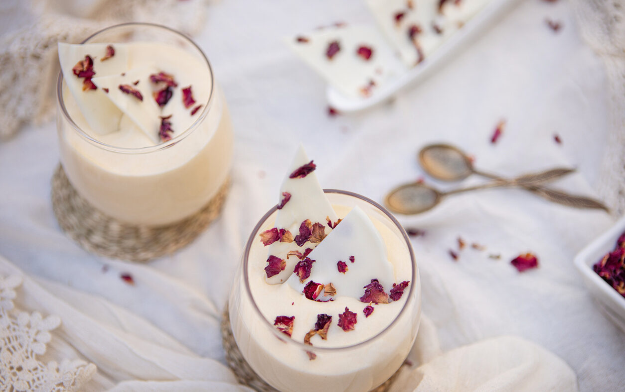 Delicious white chocolate mousse dessert with rose petals served in a glass cup - Argentine culture - Buenos Aires - Argentina