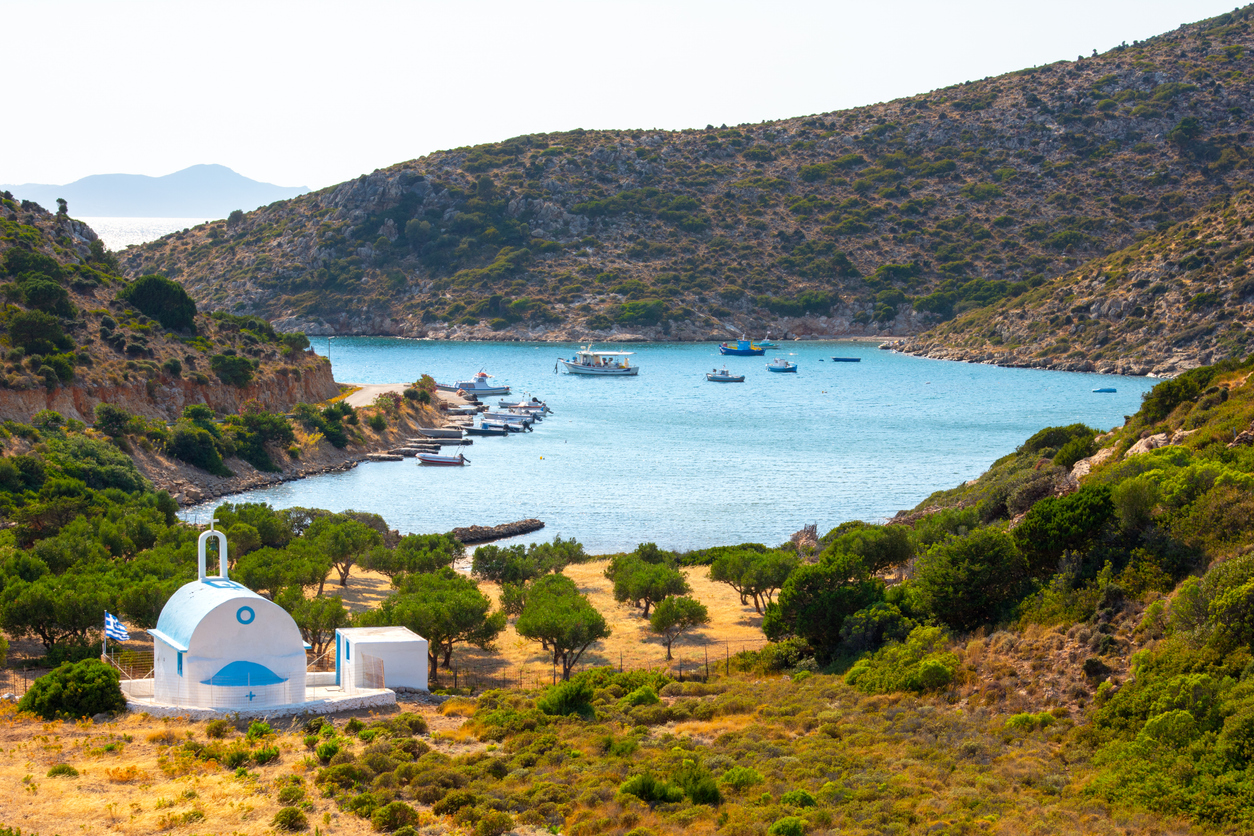 Scenic landscape with a white church of Agios Ioannis and a small harbor on Lipsi island, Greece