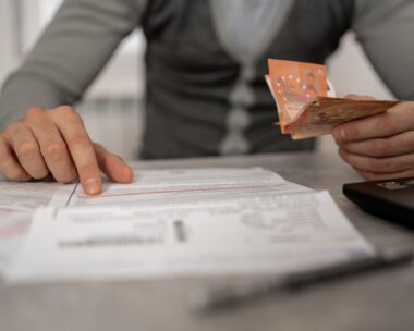With a furrowed brow and a deep sense of anxiety, the mid-adult man works to manage his bills and debt