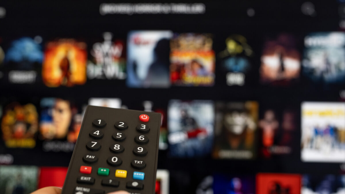 Woman hand holding tv remote.