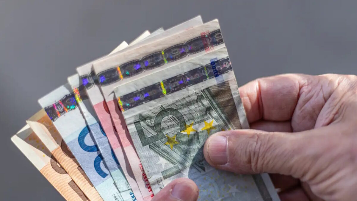Close-up of a fan of Euro banknotes held on a man's hands