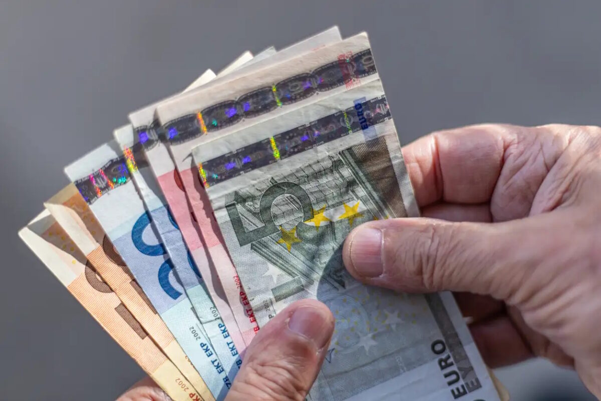 Close-up of a fan of Euro banknotes held on a man's hands