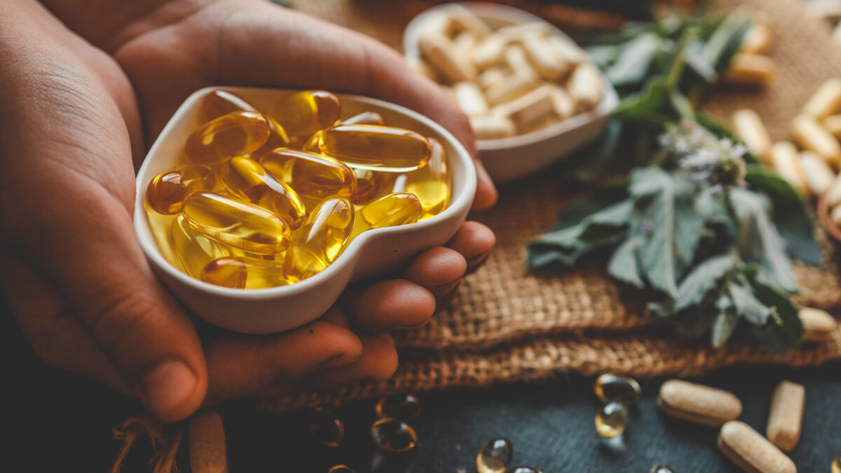 Natural organic vitamins in hands close-up.