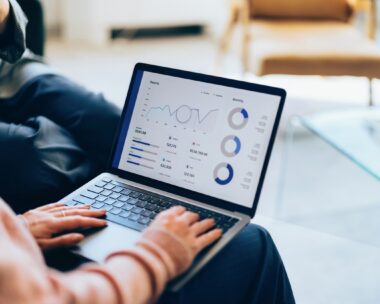 Focused on a laptop, showcasing detailed analytics and reports