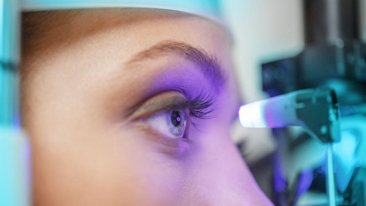 Ophthalmology - ophthalmic clinic. Ophthalmologist optometrist, medical eye examination. Tonometry, glaucoma testing. Young women, patient having a checkup, eye examined by specialist. Very shallow depth of field for soft background
