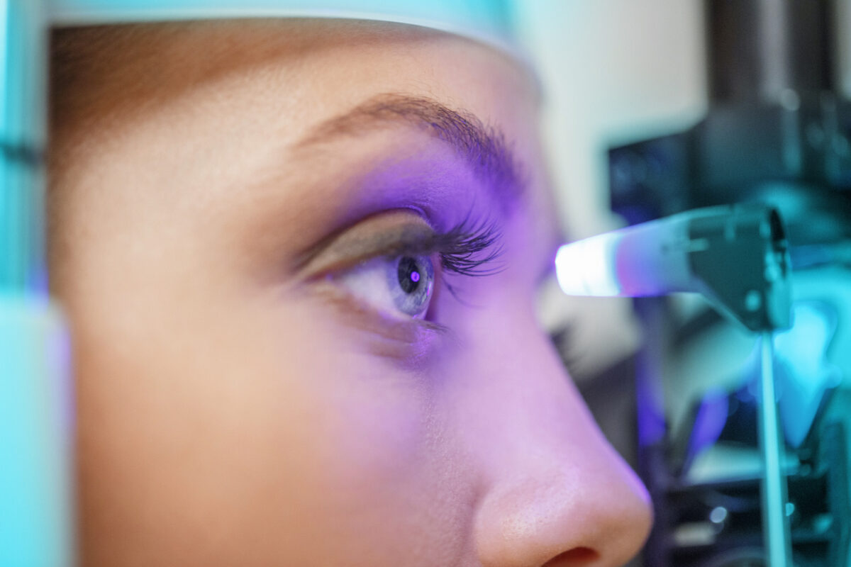 Ophthalmology - ophthalmic clinic. Ophthalmologist optometrist, medical eye examination. Tonometry, glaucoma testing. Young women, patient having a checkup, eye examined by specialist. Very shallow depth of field for soft background