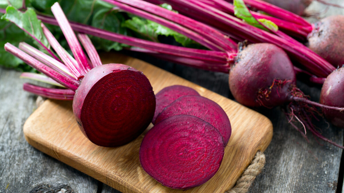 fresh sliced beetroot on wooden surface
