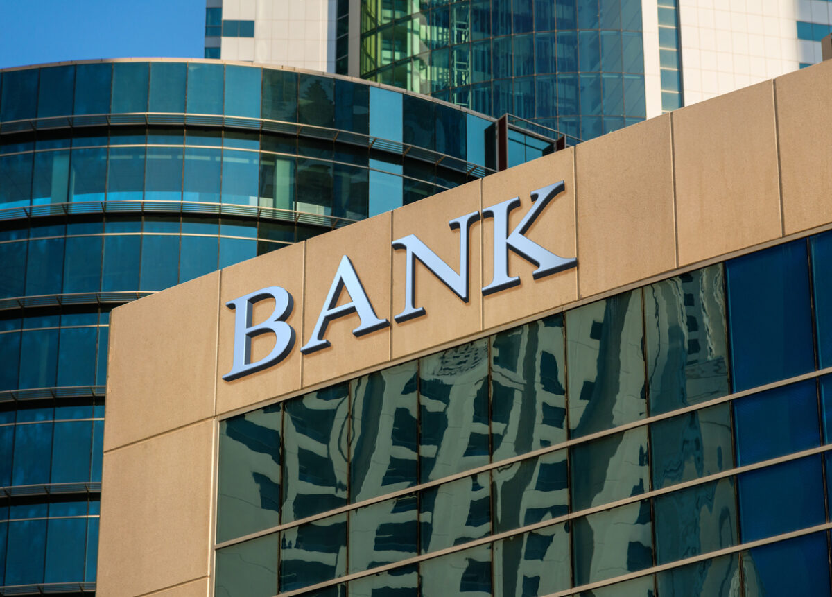 Bank sign on glass wall of business centeriStock