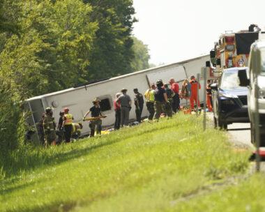 First responders work to rescue victims at the scene of a tour bus that crashed and rolled over on the New York State Thruway near Pembroke, N.Y., Friday, Aug. 22, 2025. (Libby March