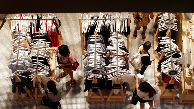 FILE PHOTO: Women shop for clothes on a store in a shopping mall in Sydney