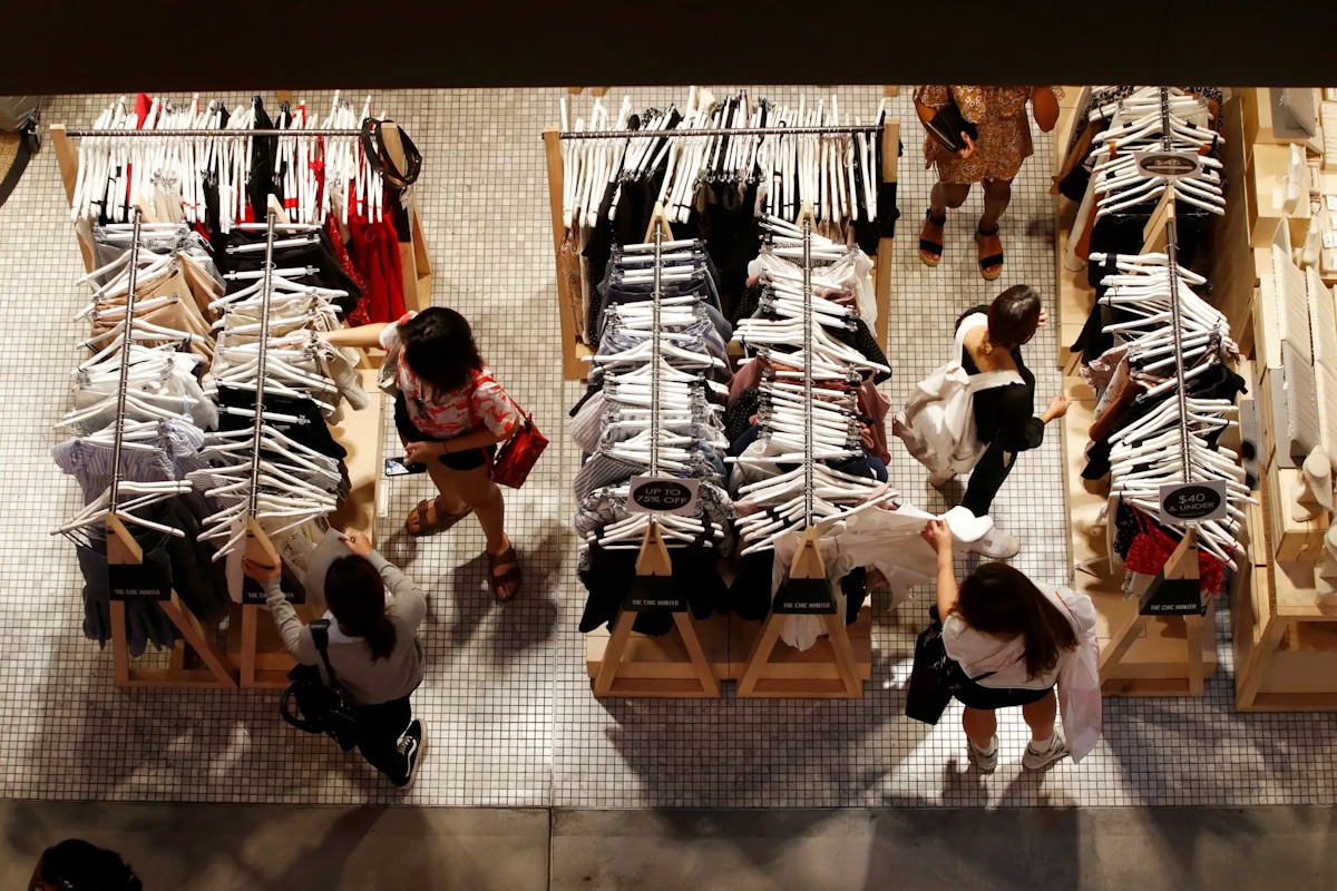 FILE PHOTO: Women shop for clothes on a store in a shopping mall in Sydney