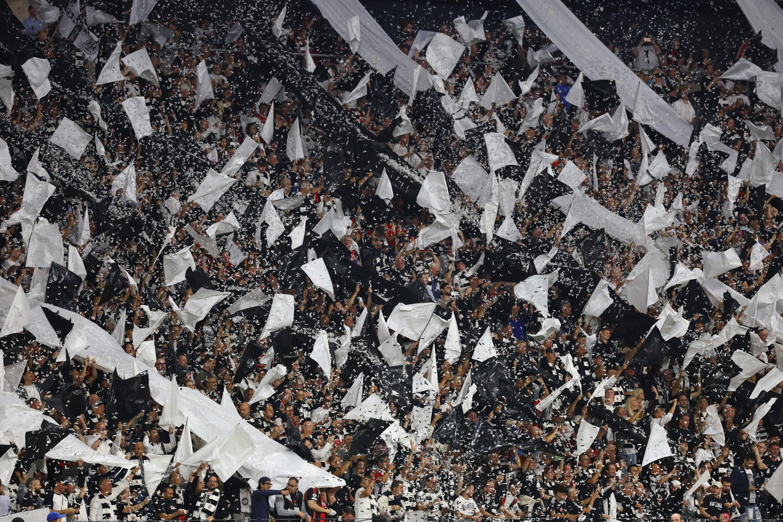 Soccer Football - UEFA Champions League - Eintracht Frankfurt v Galatasaray - Deutsche Bank Park, Frankfurt, Germany - September 18, 2025 Eintracht Frankfurt fans with flags inside the stadium as confetti falls before the match REUTERS/Kai Pfaffenbach