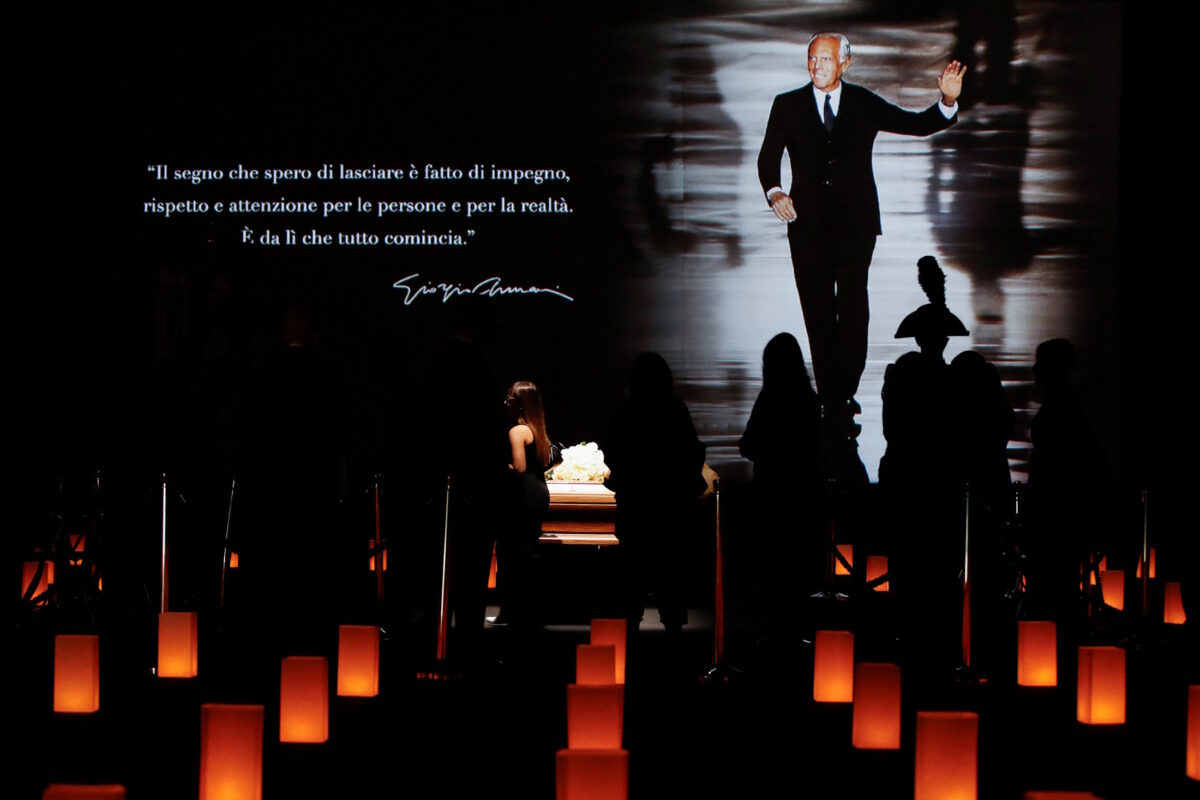 Georgio Armani's coffin with his characteristic phrase in projector