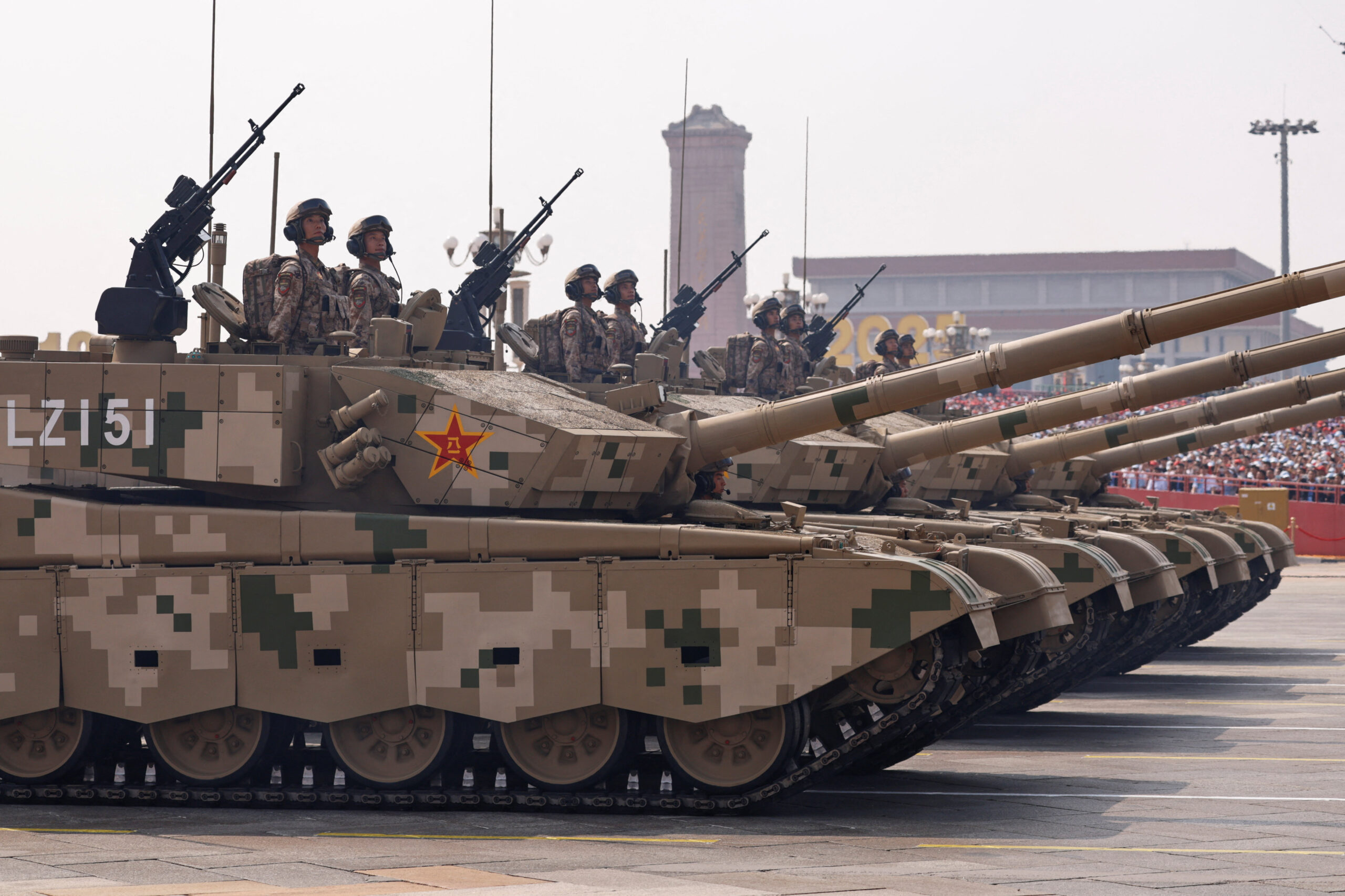 Members of the Popular Liberation Army's earthly attack force stand on armored vehicles during the military parade in Beijing