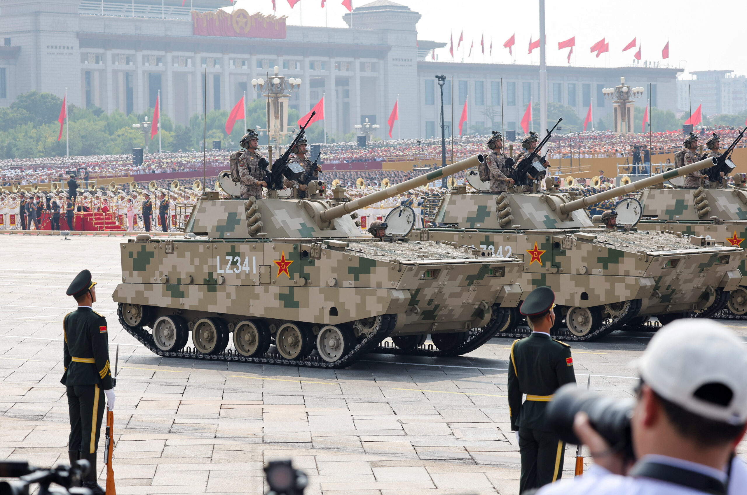 Members of the Popular Liberation Army's earthly attack force stand on armored vehicles during the military parade in Beijing