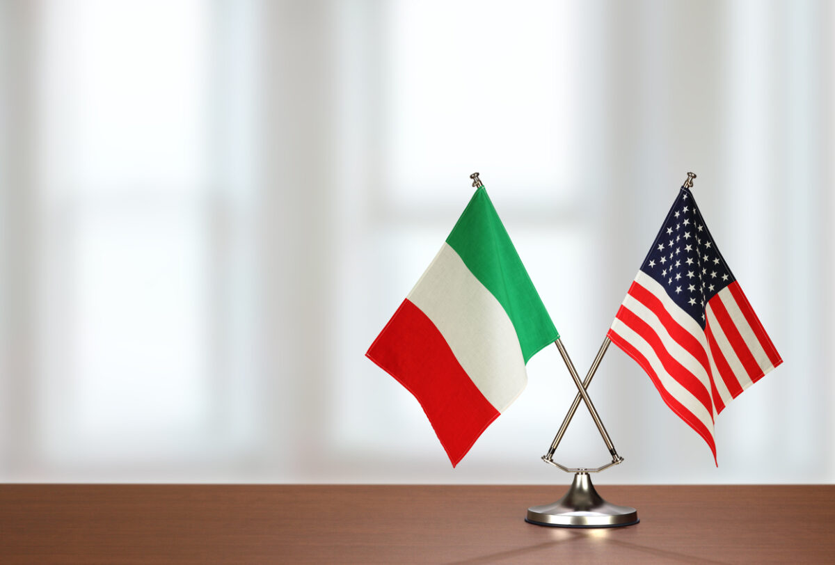 Two crossed national flags on wooden table