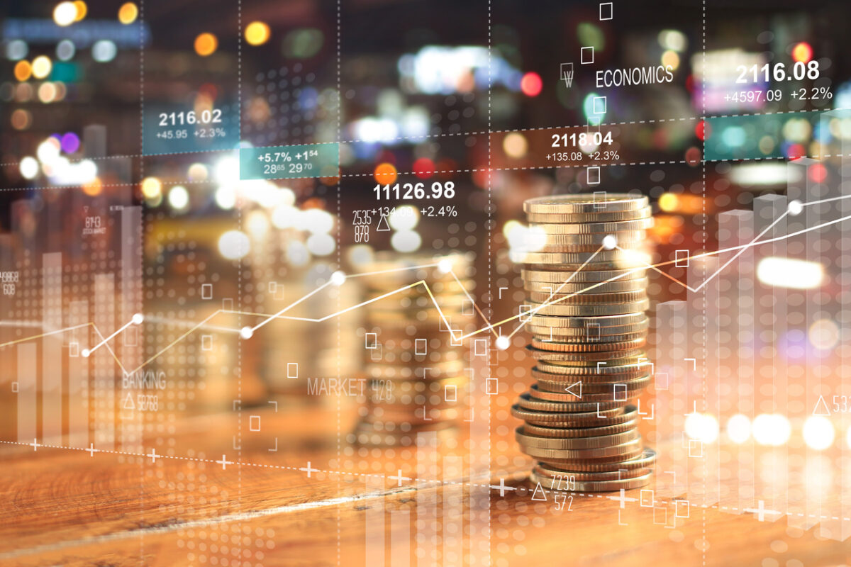 Double explosure with businesss charts of graph and rows of coins for finance at night city background