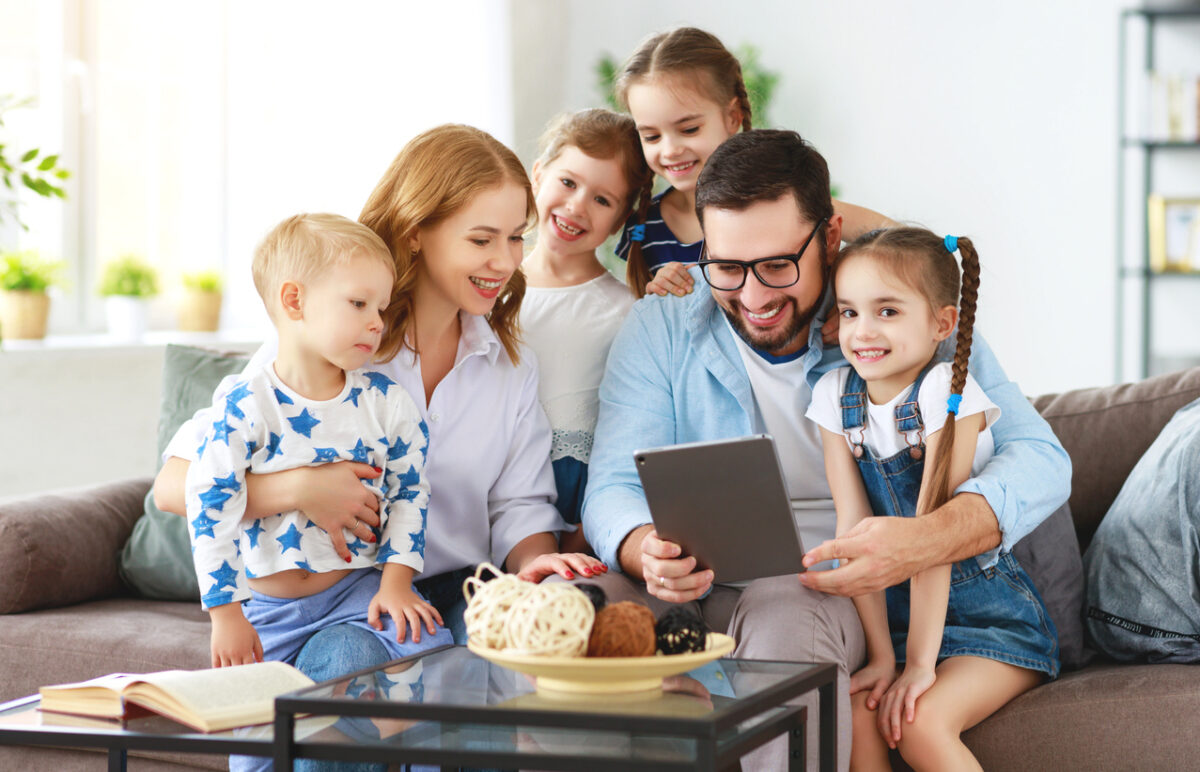 large family mother, father and four children with tablet computer at home