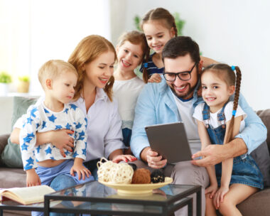 large family mother, father and four children with tablet computer at home