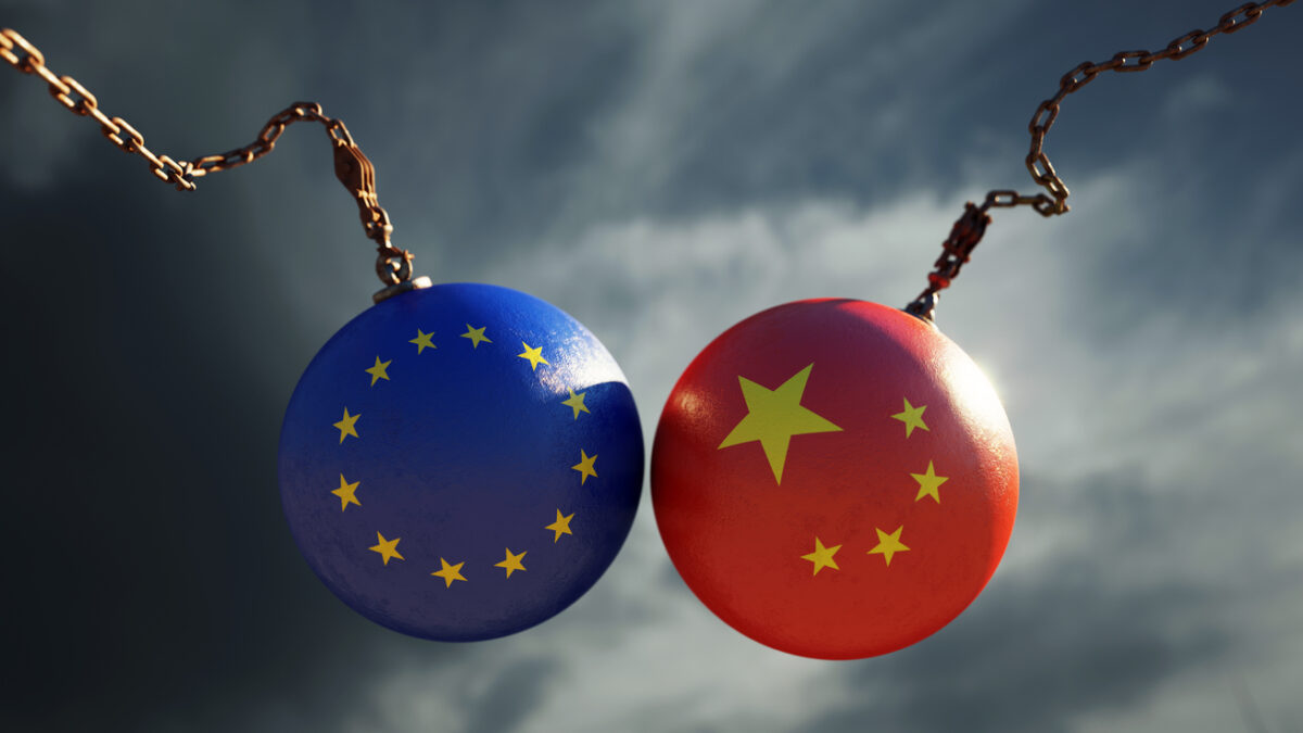 Wrecking balls textured with European Union and Chinese flags over dark stormy sky. Horizontal composition with copy space and selective focus. Dispute concept.