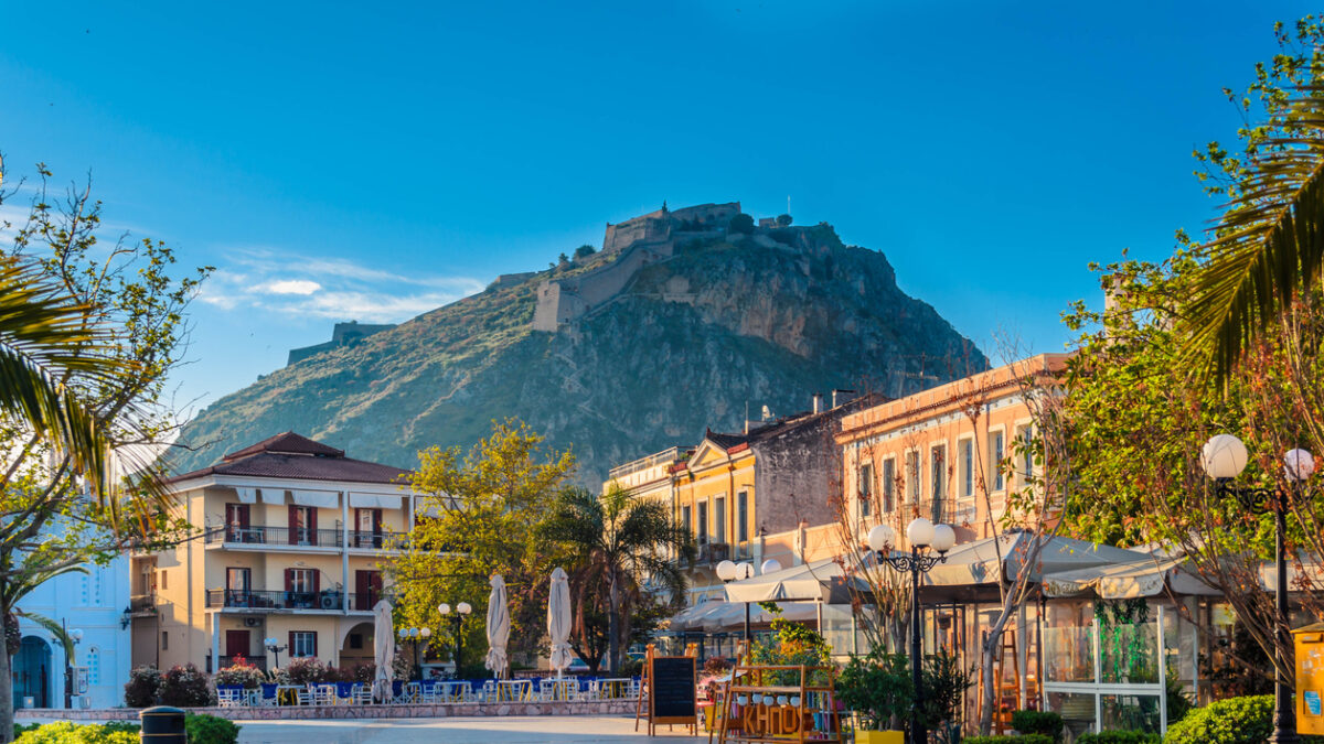 Nafplio-Greece April 12 2017 Philellinon square-The historic square of the city located in the old town.The castle of Palamidi in the background.
