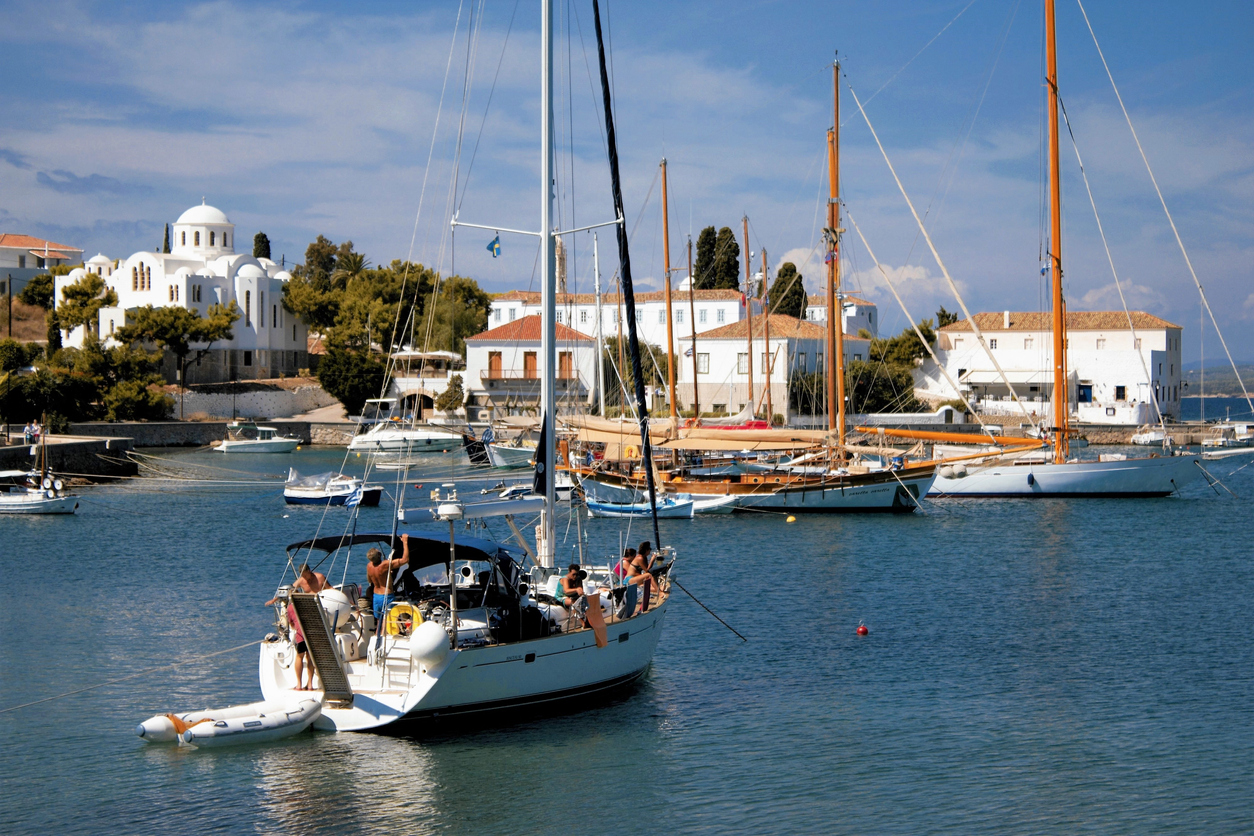 Sail boats in the old harbour of Spetses island. Saronic gulf, Greece, September 24 2015.