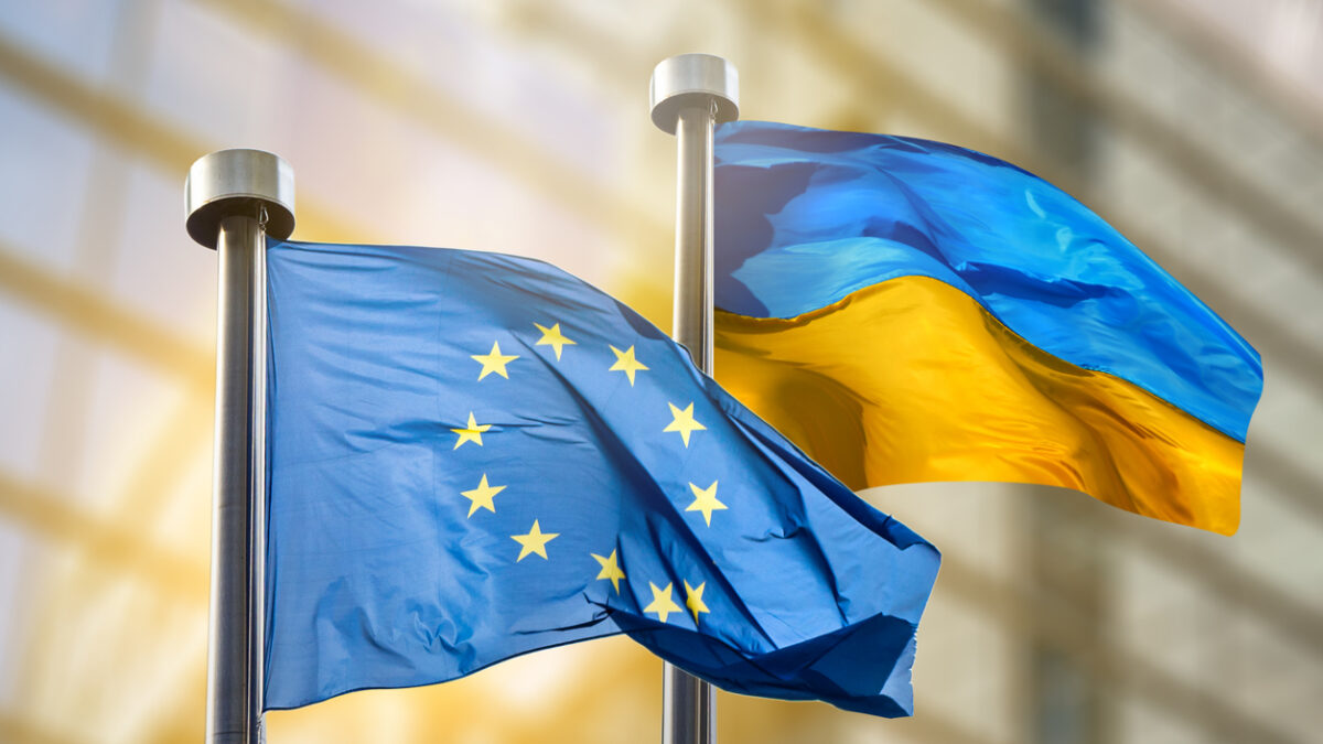 Flags of European Union and Ukraine against European Parliament bulding in Brussels, Belgium